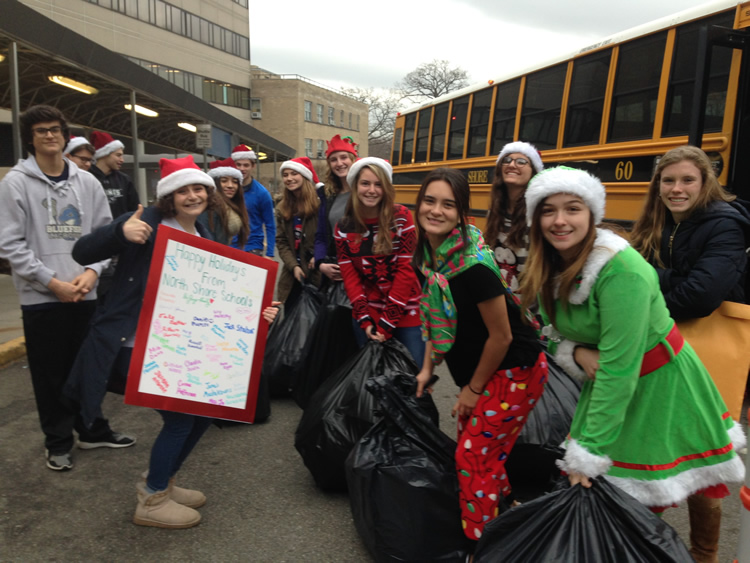 students in santa hats outside school bus