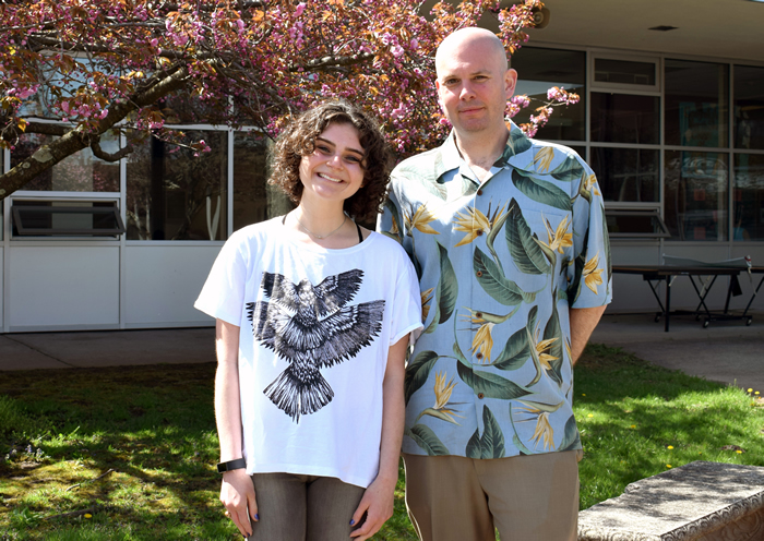 student and teacher under a flowering tree