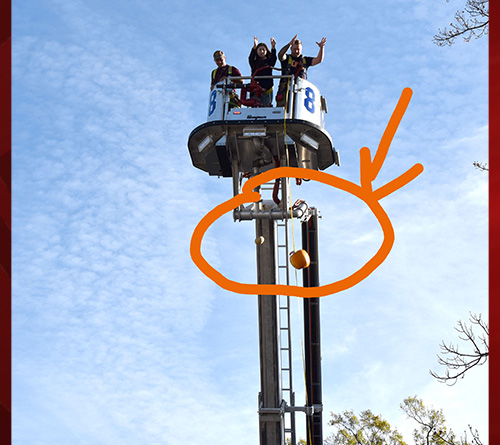 Three Students Drop the Pumpkin in the air