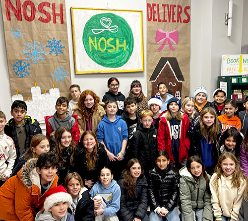 Three people dressed in cowboy and cowgirl costumes smiling outdoors during a Halloween event.