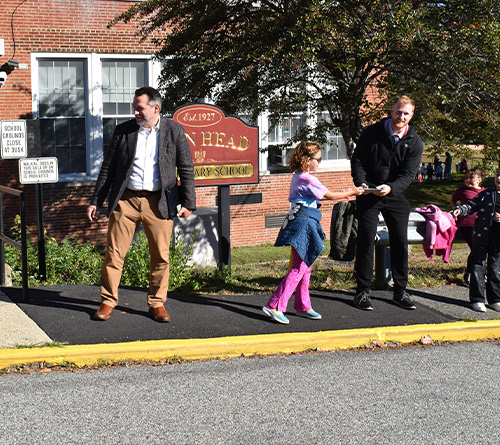student and staff lining up outside the school