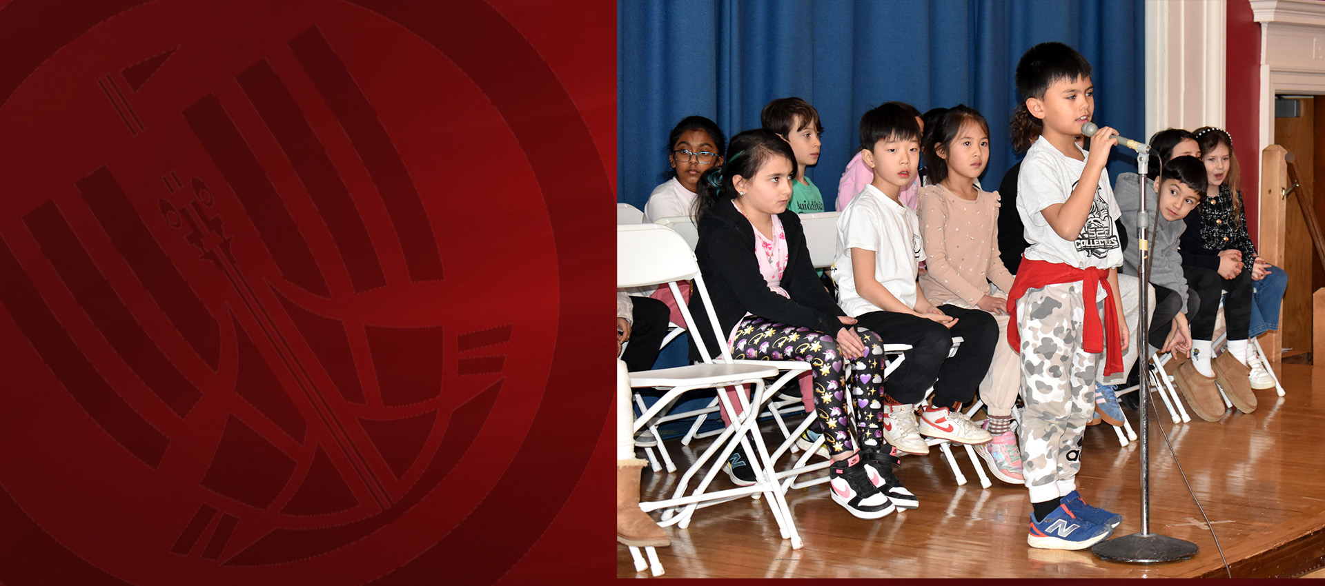 Young child talking to the mic while the other kids at the back
