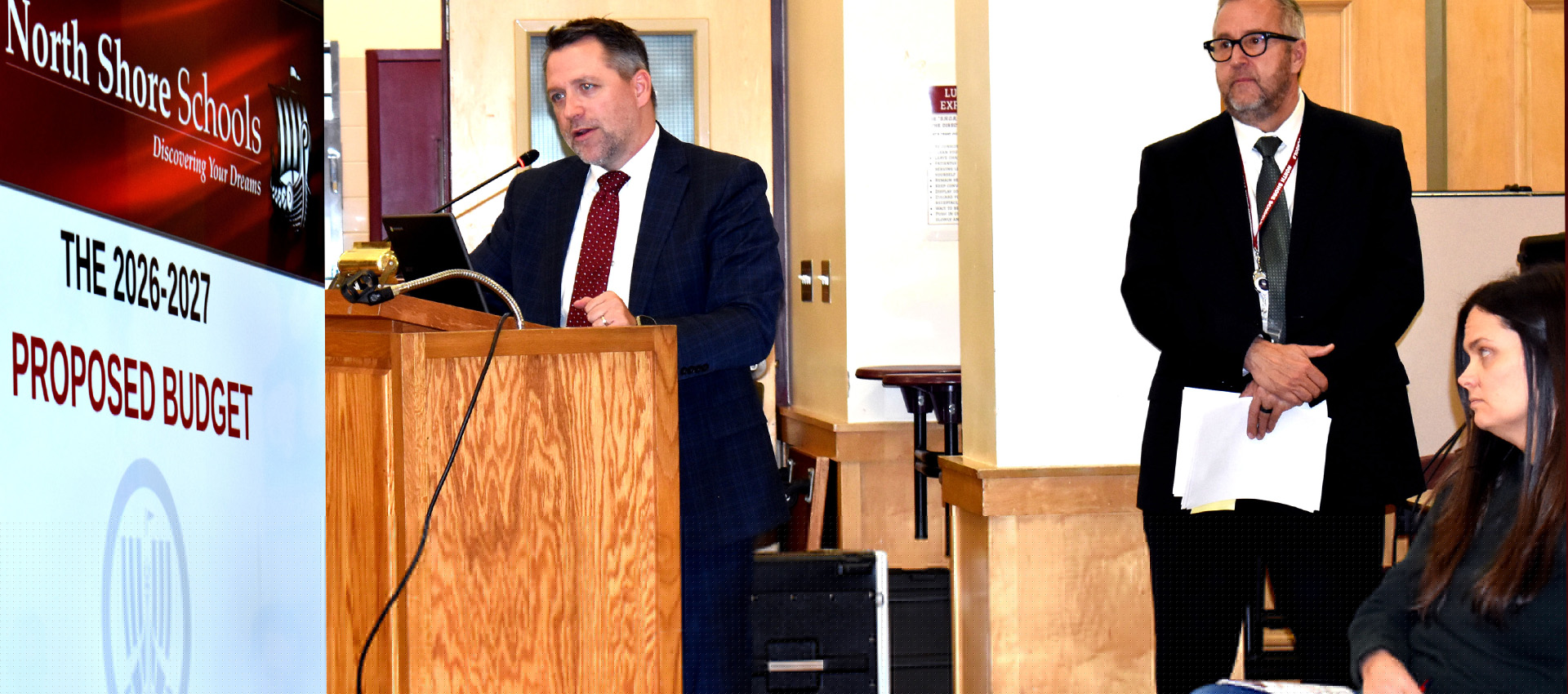 School official presenting the 2026–2027 proposed budget at a North Shore Schools board meeting.